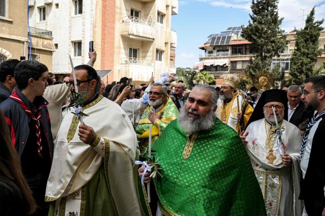 Clergymen march in a procession at the Greek Orthodox Church of the Holy Cross in the Qassaa district of Damascus on Orthodox Palm Sunday on April 5, 2026. (Photo by LOUAI BESHARA / AFP)