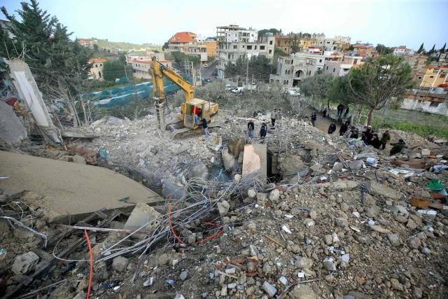 An excavator clears the rubble from the site of an overnight Israeli strike that targeted the southern Lebanese village of Kfar Hatta, on April 5, 2026. An Israeli strike on southern Lebanon's Kfar Hatta, far from the border with Israel, killed seven people on April 5 including a family of six, a source from the Lebanese civil defence told AFP. (Photo by AFP)
