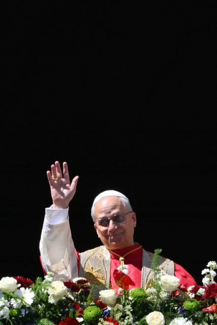 Pope Leo XIV waves to the crowd from the main balcony of St. Peter's basilica for the Urbi et Orbi message and blessing to the city and the world as part of Easter celebrations, at St Peter's square in the Vatican on April 5, 2025. (Photo by Alberto PIZZOLI / AFP)