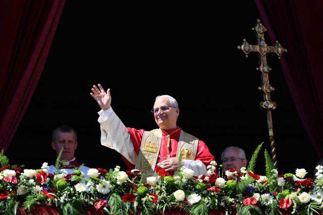 Pope Leo XIV waves to the crowd from the main balcony of St. Peter's basilica for the Urbi et Orbi message and blessing to the city and the world as part of Easter celebrations, at St Peter's square in the Vatican on April 5, 2025. (Photo by Alberto PIZZOLI / AFP)