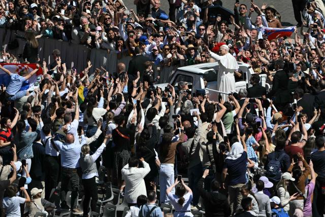 Pope Leo XIV greets the crowd from the popemobile after the Easter Mass as part of the Holy Week celebrations, at St Peter's square in the Vatican on April 5, 2026. (Photo by Andreas SOLARO / AFP)