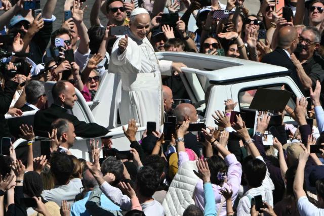 Pope Leo XIV greets the crowd from the popemobile after the Easter Mass as part of the Holy Week celebrations, at St Peter's square in the Vatican on April 5, 2026. (Photo by Andreas SOLARO / AFP)