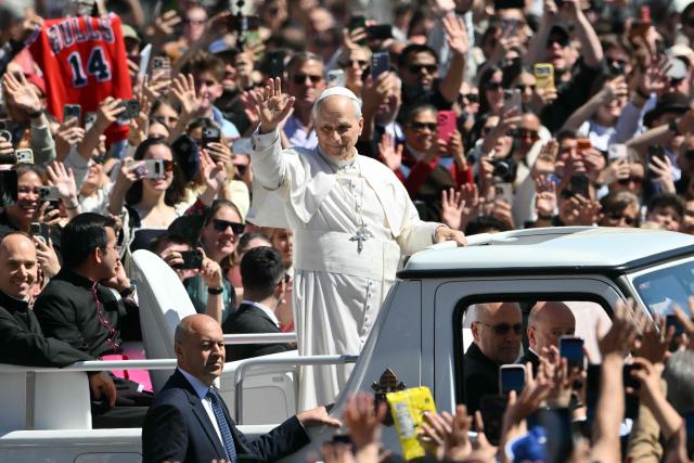 Pope Leo XIV waves to the crowd from the popemobile after the Easter Mass as part of the Holy Week celebrations, at St Peter's square in the Vatican on April 5, 2026. (Photo by Alberto PIZZOLI / AFP)