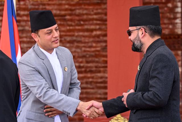 Nepal’s Prime Minister Balendra Shah (R) shakes hands with the newly elected Speaker of the House of Representatives Dol Prasad Aryal during a swearing-in ceremony in Kathmandu on April 5, 2026. (Photo by Prakash MATHEMA / AFP)