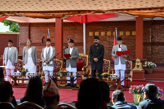 Nepal’s President Ram Chandra Paudel (C) administers the oath of office to Rastriya Swatantra Party (RSP) deputy chairman Dol Prasad Aryal (R) as the newly elected Speaker of the House of Representatives, as Prime Minister Balendra Shah (2R) looks on during a swearing-in ceremony in Kathmandu on April 5, 2026. (Photo by Prakash MATHEMA / AFP)