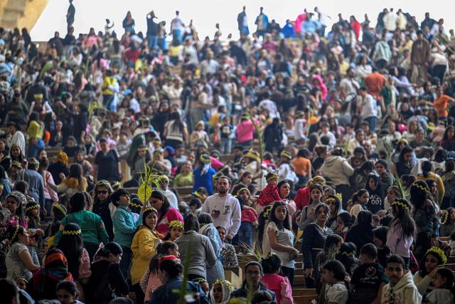 Christian worshippers attend mass at the Cave Church at the Coptic Orthodox Monastery of Simon the Tanner in the eastern hillside Mokkatam district of Cairo on Orthodox Palm Sunday on April 5, 2026. (Photo by Khaled DESOUKI / AFP)