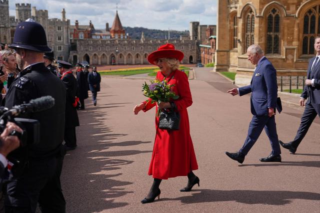 Britain's King Charles III and Britain's Queen Camilla walk over to meet members of the public as they leave St George's Chapel, in Windsor, west of London, after attending the Easter Matins Service, on April 5, 2026. (Photo by Alberto Pezzali / POOL / AFP)