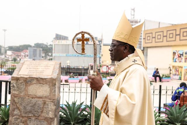 Archbishop of Yaounde Jean Mbarga stands in the courtyard of Notre Dame des Victoires Cathedral before the start of Easter Mass in Yaounde on April 5, 2026. (Photo by Daniel BELOUMOU OLOMO / AFP)