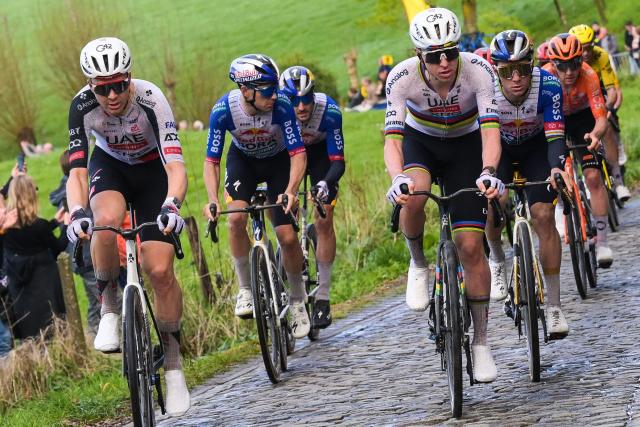 UAE Team Emirates' Slovenian rider Tadej Pogacar (R) cycles in the men's race of the 'Ronde van Vlaanderen/ Tour des Flandres/ Tour of Flanders' UCI WorldTour one day cycling race, 278 km from Antwerp to Oudenaarde, in Haaltert on April 5, 2026. (Photo by DAVID PINTENS / Belga / AFP) / Belgium OUT