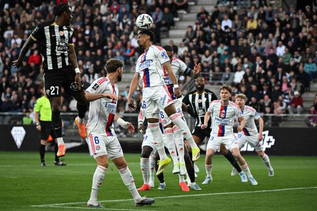 Lyon’s Brazilian defender #16 Vinicius Abner (C) heads the ball during the French L1 football match between SCO Angers and Olympique Lyonnais (OL) at the Stade Raymond-Kopa in Angers on April 5, 2026. (Photo by Sebastien Salom-Gomis / AFP)