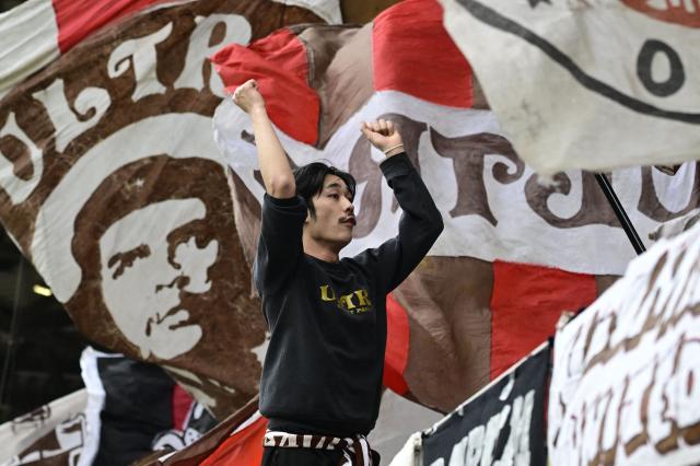 St Pauli supporters wave flags ahead the German first division Bundesliga football match between Union Berlin and St Pauli in Berlin on April 5, 2026. (Photo by John MACDOUGALL / AFP) / DFL REGULATIONS PROHIBIT ANY USE OF PHOTOGRAPHS AS IMAGE SEQUENCES AND/OR QUASI-VIDEO