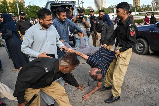 Police personnel detain supporters of Pakistan’s opposition Pakistan Tehreek-e-Insaf (PTI) party as they protest against a fuel price hike in Karachi on April 5, 2026. Pakistan drastically raised fuel prices in response to spiking global prices caused by the Iran war, the country's petroleum minister said. (Photo by Asif HASSAN / AFP)