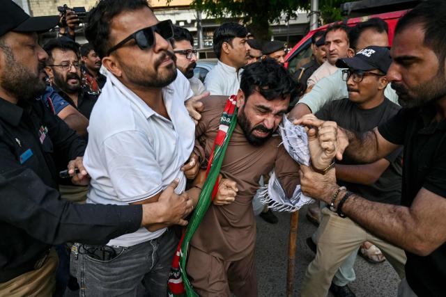 Police personnel detain supporters of Pakistan’s opposition Pakistan Tehreek-e-Insaf (PTI) party as they protest against a fuel price hike in Karachi on April 5, 2026. Pakistan drastically raised fuel prices in response to spiking global prices caused by the Iran war, the country's petroleum minister said. (Photo by Asif HASSAN / AFP)