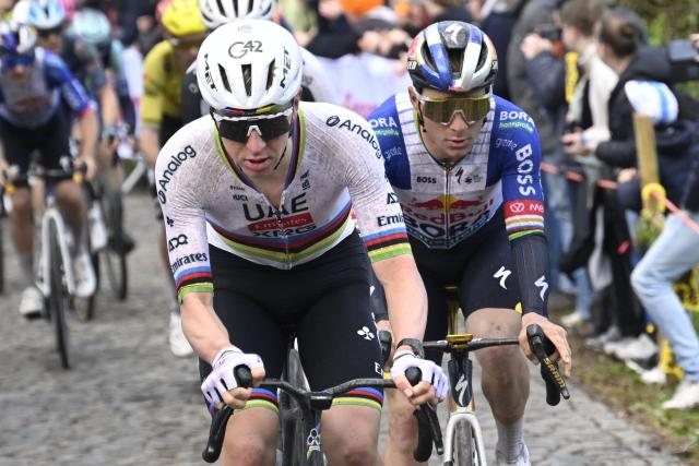 UAE Team Emirates' Slovenian rider Tadej Pogacar and Red Bull-BORA-hansgrohe's Belgian rider Remco Evenepoel cycle in the men's race of the 'Ronde van Vlaanderen/ Tour des Flandres/ Tour of Flanders' UCI WorldTour one day cycling race, 278 km from Antwerp to Oudenaarde, in Haaltert on April 5, 2026. (Photo by Nico VEREECKEN / Belga / AFP) / Belgium OUT