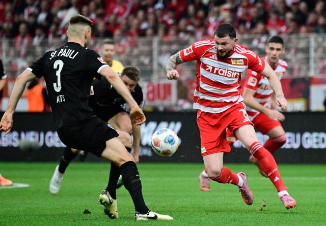 St Pauli's Estonian defender #03 Karol Mets (L) and Union Berlin's Scottish forward #07 Oliver Burke vie for the ball during the German first division Bundesliga football match between Union Berlin and St Pauli in Berlin on April 5, 2026. (Photo by John MACDOUGALL / AFP) / DFL REGULATIONS PROHIBIT ANY USE OF PHOTOGRAPHS AS IMAGE SEQUENCES AND/OR QUASI-VIDEO