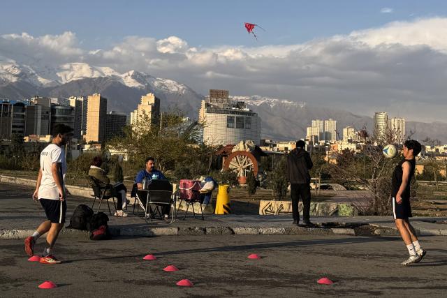 People exercise and play at the Pardisan Park in Tehran on April 5, 2026. The war, which erupted on February 28, 2026 with US-Israeli strikes on Iran, has engulfed the Middle East and convulsed the global economy. (Photo by ATTA KENARE / AFP)