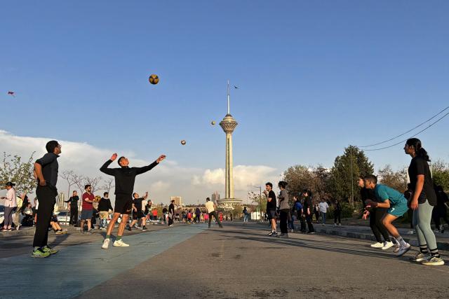 People exercise and play at the Pardisan Park in Tehran on April 5, 2026. The war, which erupted on February 28, 2026 with US-Israeli strikes on Iran, has engulfed the Middle East and convulsed the global economy. (Photo by ATTA KENARE / AFP)