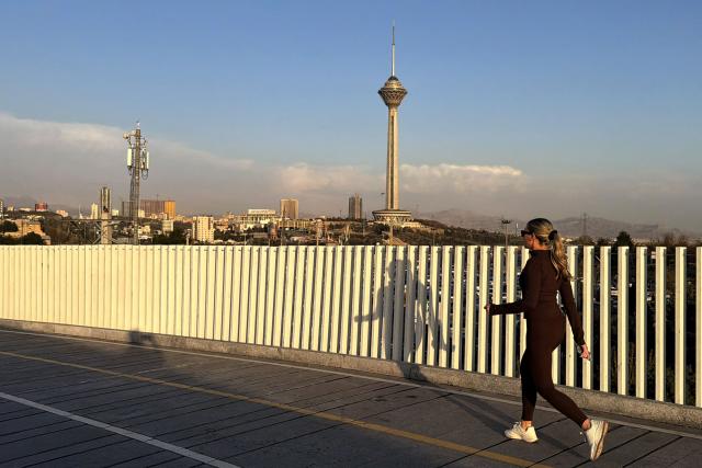 A woman jogs through the Pardisan Park in Tehran on April 5, 2026. The war, which erupted on February 28, 2026 with US-Israeli strikes on Iran, has engulfed the Middle East and convulsed the global economy. (Photo by ATTA KENARE / AFP)