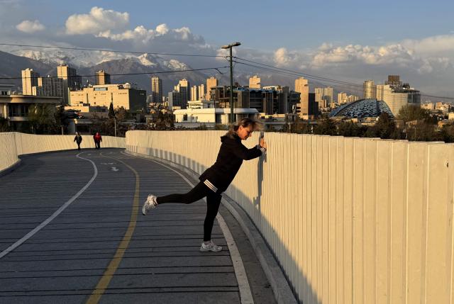 A woman exercises at the Pardisan Park in Tehran on April 5, 2026. The war, which erupted on February 28, 2026 with US-Israeli strikes on Iran, has engulfed the Middle East and convulsed the global economy. (Photo by ATTA KENARE / AFP)