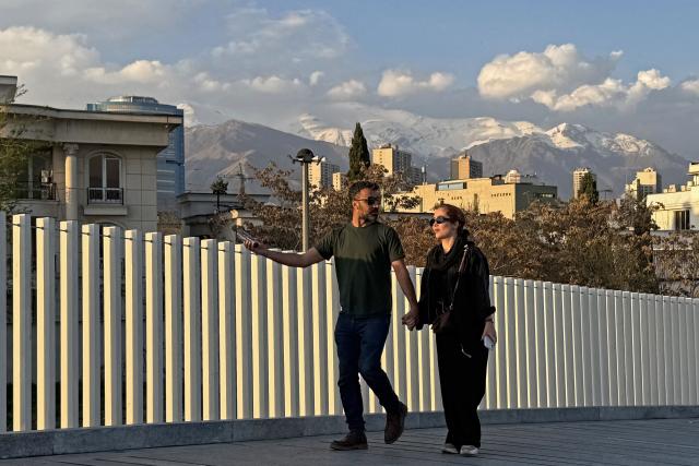 People walk along the Pardisan Park in Tehran on April 5, 2026. The war, which erupted on February 28, 2026 with US-Israeli strikes on Iran, has engulfed the Middle East and convulsed the global economy. (Photo by ATTA KENARE / AFP)