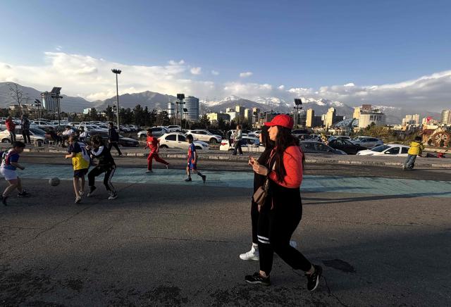 Women walk along the Pardisan Park in Tehran on April 5, 2026. The war, which erupted on February 28, 2026 with US-Israeli strikes on Iran, has engulfed the Middle East and convulsed the global economy. (Photo by ATTA KENARE / AFP)