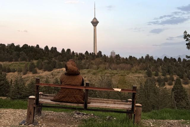 An Iranian youth sits at the Pardisan Park in Tehran on April 5, 2026. The war, which erupted on February 28, 2026 with US-Israeli strikes on Iran, has engulfed the Middle East and convulsed the global economy. (Photo by ATTA KENARE / AFP)