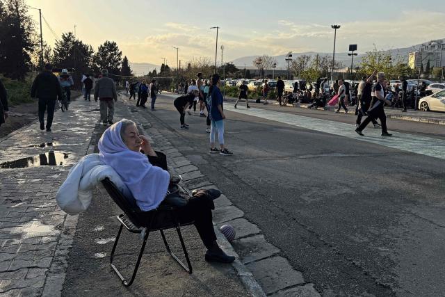 People visit the Pardisan Park in Tehran on April 5, 2026. The war, which erupted on February 28, 2026 with US-Israeli strikes on Iran, has engulfed the Middle East and convulsed the global economy. (Photo by ATTA KENARE / AFP)