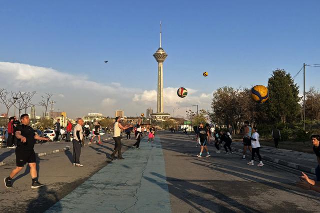 People exercise and play at the Pardisan Park in Tehran on April 5, 2026. The war, which erupted on February 28, 2026 with US-Israeli strikes on Iran, has engulfed the Middle East and convulsed the global economy. (Photo by ATTA KENARE / AFP)