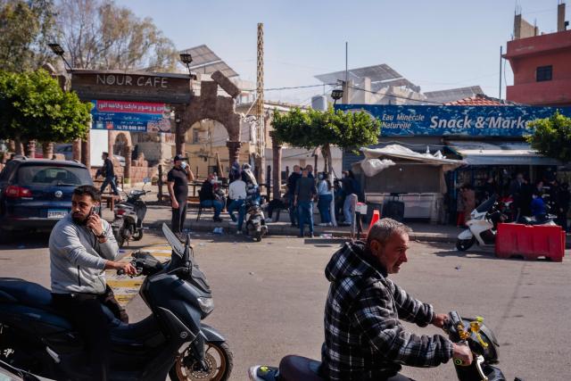 People ride motorcycles near the site of an Israeli strike in Jnah neighbourhood of Beirut on April 5, 2026. An Israeli strike hit south Beirut on April 5, Lebanese state media reported, with a medical source telling AFP it made impact about 100 metres away from a public hospital. The strike hit Beirut's Jnah neighbourhood near Rafik Hariri University Hospital, the largest public medical facility in the country. (Photo by Dimitar DILKOFF / AFP)