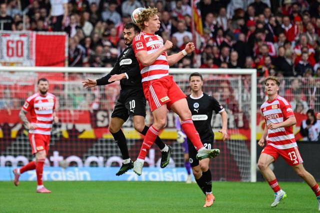 St Pauli's Luxembourg forward #10 Daniel Sinani and Union Berlin's Austrian defender #14 Leopold Querfeld both jump to head the ball during the German first division Bundesliga football match between Union Berlin and St Pauli in Berlin on April 5, 2026. (Photo by John MACDOUGALL / AFP) / DFL REGULATIONS PROHIBIT ANY USE OF PHOTOGRAPHS AS IMAGE SEQUENCES AND/OR QUASI-VIDEO