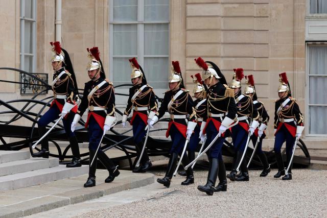 (FILES) French Republican guards of honor arrive in the courtyard before a welcoming ceremony at the Elysee Palace in Paris on October 8, 2025. An investigation is underway in Paris following a complaint filed by a gendarme who denounces ‘racist harassment’ within the prestigious Republican Guard. The 29-year-old serviceman filed his complaint on December 17, 2025, and was then interviewed on January 21, 2026, according to a source close to the case. (Photo by Ludovic MARIN / AFP)
