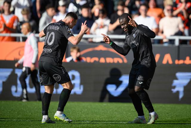 Lorient's Senegalese forward #12 Bamba Dieng (R) celebrates after scoring his team's first goal during the French L1 football match between FC Lorient and Paris FC  at the Stade du Moustoir in Lorient, western France on April 5, 2026. (Photo by Loic VENANCE / AFP)