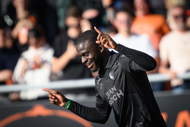 Lorient's Senegalese forward #12 Bamba Dieng celebrates after scoring his team's first goal during the French L1 football match between FC Lorient and Paris FC  at the Stade du Moustoir in Lorient, western France on April 5, 2026. (Photo by Loic VENANCE / AFP)