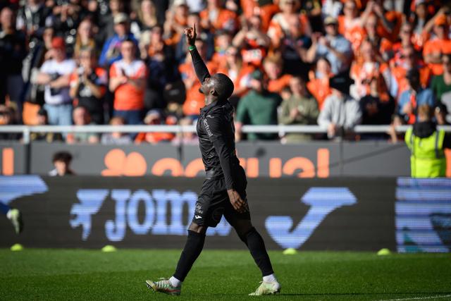Lorient's Senegalese forward #12 Bamba Dieng celebrates after scoring his team's first goal during the French L1 football match between FC Lorient and Paris FC  at the Stade du Moustoir in Lorient, western France on April 5, 2026. (Photo by Loic VENANCE / AFP)