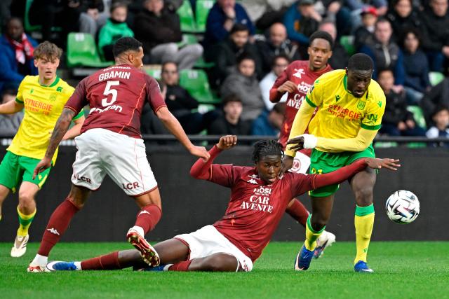Metz's French midfielder #33 Believe Munongo (C) and Nantes' French midfielder #21 Mohamed Kaba (R) fight for the ball during the French L1 football match between FC Metz and FC Nantes at the Stade Saint-Symphorien in Longeville-les-Metz, eastern France, on April 5, 2026. (Photo by Jean-Christophe VERHAEGEN / AFP)