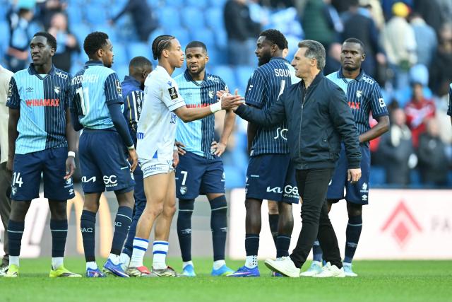 Auxerre's French head coach Christophe Pelissier congratulates Auxerre's French midfielder #05 Kevin Danois at the end of the French L1 football match between Le Havre AC and AJ Auxerre at the Oceane Stadium in Le Havre, Normandy, on April 5, 2026. (Photo by Lou BENOIST / AFP)