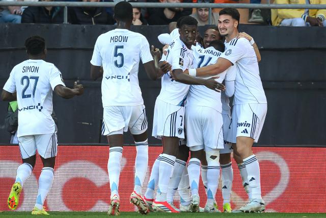 Paris FC's players celebrate after scoring their team's first goal during the French L1 football match between FC Lorient and Paris FC  at the Stade du Moustoir in Lorient, western France on April 5, 2026. (Photo by Loic VENANCE / AFP)