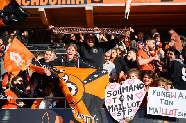 Lorient's supporters cheer on their team during the French L1 football match between FC Lorient and Paris FC  at the Stade du Moustoir in Lorient, western France on April 5, 2026. (Photo by Loic VENANCE / AFP)