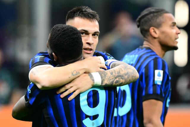 Inter Milan's Argentinian forward #10 Lautaro Martinez celebrates scoring his team's first goal with Inter Milan's French forward #9 Marcus Thuram during the Italian Serie A football match between Inter Milan and AS Roma at San Siro stadium in Milan, on April 5, 2026. (Photo by Stefano RELLANDINI / AFP)