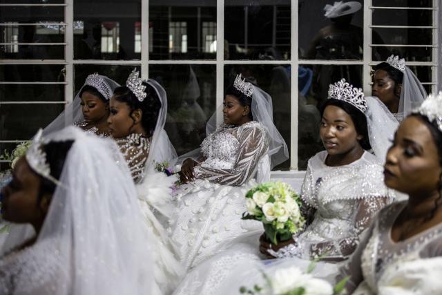 Brides wait to enter the church during the Easter 2026 mass wedding ceremony at the International Pentecost Holiness Church (IPHC) headquarters in Zuurbekom, Westonaria, on April 5, 2026. (Photo by ILARIA FINIZIO / AFP)