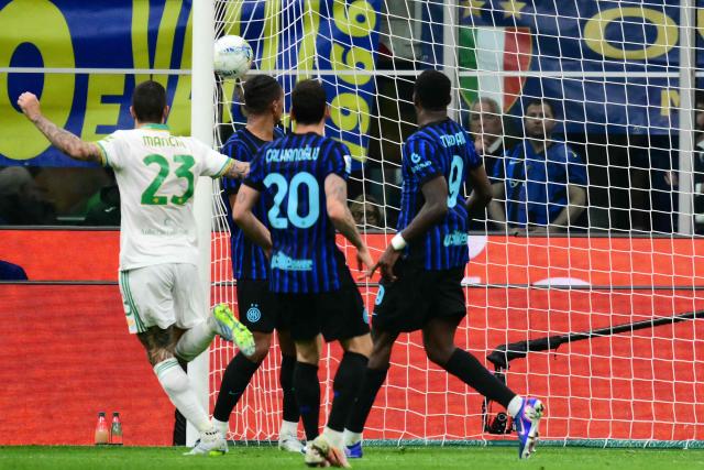 Roma's Italian defender #23 Gianluca Mancini scores his team's first goal during the Italian Serie A football match between Inter Milan and AS Roma at San Siro stadium in Milan, on April 5, 2026. (Photo by Stefano RELLANDINI / AFP)