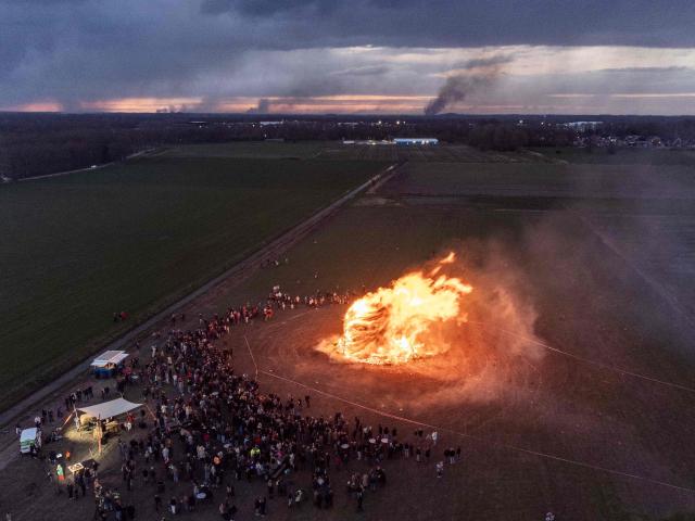 This aerial photograph shows a traditional Easter bonfire burning during Easter celebrations in the hamlet of Beuseberg, near Holten, on April 5, 2026. (Photo by Vincent Jannink / ANP / AFP) / Netherlands OUT