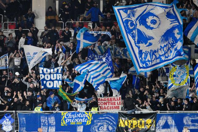 Marseille's supporters cheer their team on from the stands during the French L1 football match between Monaco (ASM) and Olympique de Marseille (OM) at the Louis II Stadium in Monaco on April 5, 2026. (Photo by Frederic DIDES / AFP)