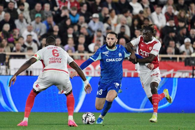 Marseille's Algerian forward #09 Amine Gouiri (C) fights for the ball with Monaco's French midfielder #28 Mamadou Coulibaly (R) and Monaco's Swiss midfielder #06 Denis Zakaria (L) during the French L1 football match between Monaco (ASM) and Olympique de Marseille (OM) at the Louis II Stadium in Monaco on April 5, 2026. (Photo by Frederic DIDES / AFP)