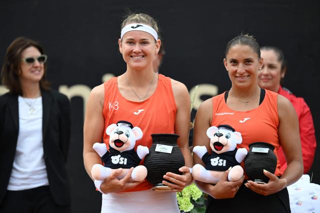 Czech Republic's Marie Bouzkova (L) holds the trophy next to Hungary's Panna Udvardy after defeating her in the WTA Bogota women's singles final match at the Country Club in Bogota on April 5, 2026. (Photo by RAUL ARBOLEDA / AFP)