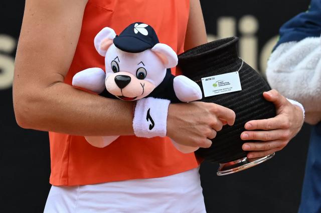 Czech Republic's Marie Bouzkova holds the trophy and a stuffed toy after defeating Hungary's Panna Udvardy in the WTA Bogota women's singles final match at the Country Club in Bogota on April 5, 2026. (Photo by RAUL ARBOLEDA / AFP)