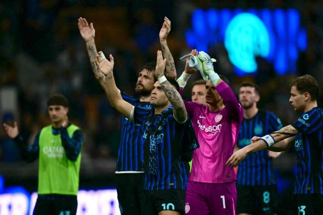Inter Milan's Argentinian forward #10 Lautaro Martinez, Inter Milan's Swiss goalkeeper #1 Yann Sommer and Inter Milan's Italian midfielder #23 Nicolo Barella greet supporters at the end of the Italian Serie A football match between Inter Milan and AS Roma at San Siro stadium in Milan, on April 5, 2026. (Photo by Stefano RELLANDINI / AFP)