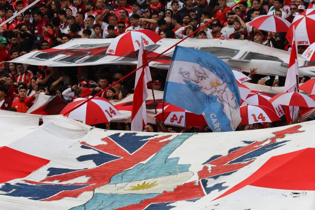 River Plate fans display a flag with an image of the Islas Malvinas, in commemoration of the 1982 armed conflict between Argentina and England over the islands, before the Argentine Professional Football League 2026 Apertura Tournament match between River Plate and Belgrano at MAS Monumental stadium in Buenos Aires on April 5, 2026. (Photo by ALEJANDRO PAGNI / AFP)