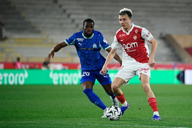 Monaco's Russian midfielder #10 Aleksandr Golovin (R) dribbles past Marseille's Ivorian midfielder #20 Hamed Junior Traore during the French L1 football match between Monaco (ASM) and Olympique de Marseille (OM) at the Louis II Stadium in Monaco on April 5, 2026. (Photo by Frederic DIDES / AFP)