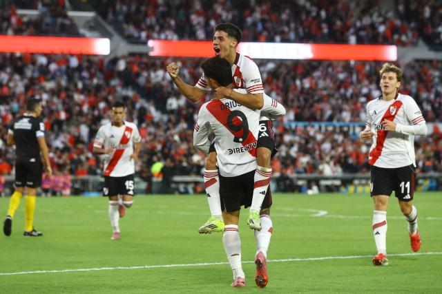 River Plate midfielder #26 Tomas Galvan (2nd R) celebrates after scoring the first goal during the Argentine Professional Football League 2026 Apertura Tournament match between River Plate and Belgrano at MAS Monumental stadium in Buenos Aires on April 5, 2026. (Photo by ALEJANDRO PAGNI / AFP)